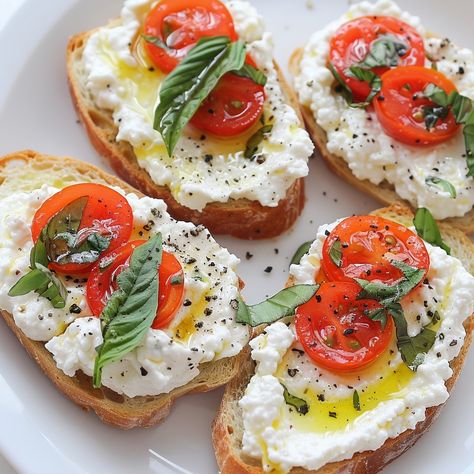 🍋🌿 Fresh and flavorful, these Lemon Basil Ricotta Crostini are a must-try! #Appetizers #FreshFlavors Lemon Basil Ricotta Crostini Ingredients: Baguette slices (12, toasted) Ricotta cheese (1 cup) Lemon zest (1 tsp) Fresh basil (1/4 cup, chopped) Olive oil (2 tbsp) Salt (to taste) Black pepper (to taste) Cherry tomatoes (1 cup, halved, optional) Instructions: In a bowl, mix ricotta cheese, lemon zest, fresh basil, salt, and pepper. Spread the ricotta mixture on toasted baguette slices. Dri... Guacamole Bruschetta, New Years Foods, Ricotta Bruschetta, Toasted Baguette Slices, Fancy Toast, Spring Dinner Party, Ricotta Crostini, Ricotta Cheese Recipes, Baguette Slices