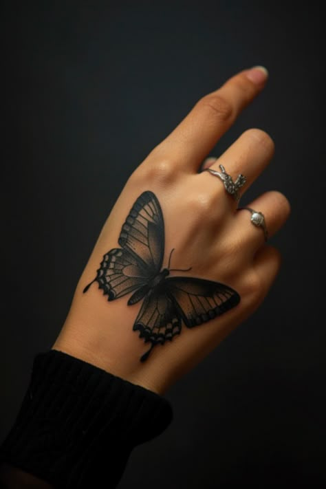 Hand with a detailed butterfly tattoo and silver rings on fingers. Girly Butterfly Tattoos, Butterfly Tattoo On Hand For Women, Back Of Hand Tattoo Women, Butterfly Back Of Arm Tattoo, Wrist And Hand Tattoos For Women, Hand Tattoos For Women Unique Beautiful, Girl Hand Tattoos Ideas, Butterfly Hand Tattoo For Women, Hand Tattoo Placement