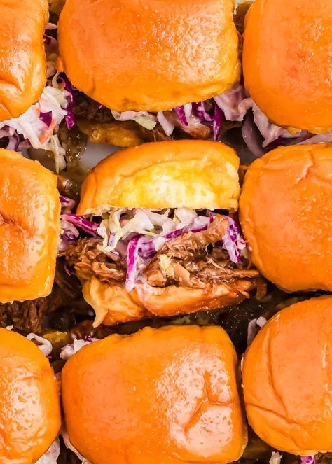 Make the ultimate BBQ pulled pork sliders with this easy pulled pork slider recipe! Tender pulled pork, topped with tangy coleslaw, all served on soft Hawaiian rolls, makes these sliders perfect for game days or parties. Whether you're using the slow cooker or Instant Pot, these pulled pork sliders come together effortlessly and will be a hit with any crowd. Slow Cooker Pulled Pork Sliders, Pulled Pork Hawaiian Rolls Sliders, Pulled Pork Slow Cooker Easy, Bbq Sliders Recipes Hawaiian Rolls, Pulled Pork Sliders Hawaiian Rolls, Hand Sandwiches, Kalua Pork Sliders, Barbecue Sliders, Sliders With Hawaiian Rolls