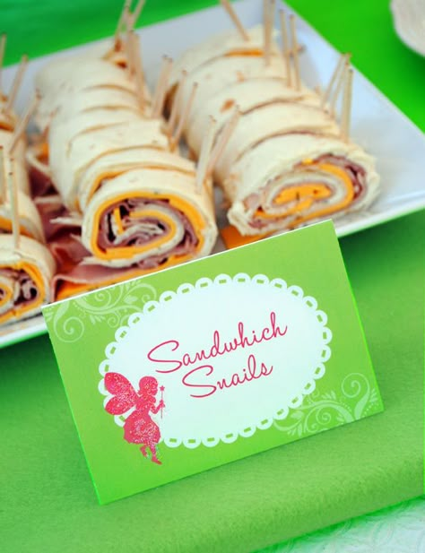 Sandwich Snails**Flour Tortillas,  Cheese,Ham or Turkey lunch meat,  Chive Cream Cheese,small stick pretzels* Spread cream cheese on tortilla. Add 1 layer of cheese & meat on top of cream cheese. Roll up tortilla,cut into 1 1/2" thick pieces.Stick pretzels at one end for snail antennae* Fairy Party Food, Tinker Bell Party, Woodland Fairy Party, Fairy Tea Party, Tinkerbell Birthday, Fairy Garden Birthday, Fairy Baby Showers, Fairy Food, Fairy Garden Birthday Party