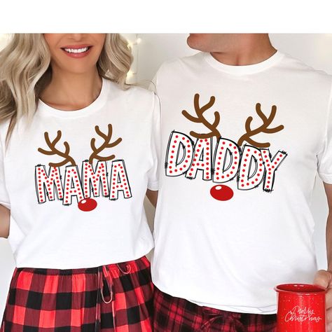 **Note your items will be printed on white or black t-shirt. Capture those picture-perfect Family Matching moments with our Christmas Family Shirts! These match family shirts are designed to make your Christmas Morning photos unforgettable. With a family shirt match like this, you'll have an adorable  look that's both fun and festive for your Christmas Season Family outtings. WHY YOU"LL LOVE IT: This classic unisex jersey short sleeve tee fits like a well-loved favorite, ensuring comfort and sty Matching Christmas Shirts Families Teepublic, Family Christmas Tee Shirts Ideas, First Christmas Matching Shirts, Diy Family Christmas Shirts, Family Matching Holiday T-shirt With Letter Print, Holiday White Top With Custom Print, White Top With Custom Print For Holidays, White Custom Print Tops For Holiday, Holiday White Custom Print Top