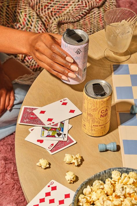 Girl picking up cann social tonic weed beverage surrounded by cards, popcorn, and chess set Lifestyle Photography Food, Woman Photographer, Beer Photography, Food Photoshoot, Photo Food, Product Photographer, Food Product, Photography Food, Branding Photoshoot