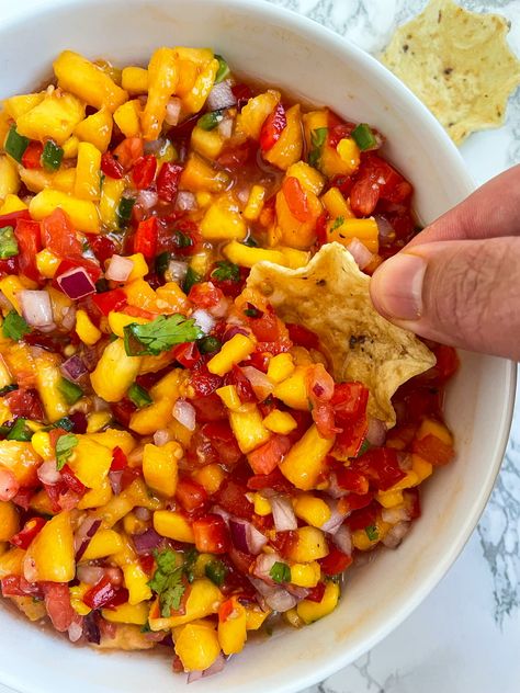 This Peach Mango Salsa is so delicious on top of fish tacos, regular tacos, any Mexican inspired cuisine, or just alone with chips Peach Mango Salsa Recipe For Canning, Fruit Salsa For Tacos, Sweet Mango Salsa, Peach And Mango Salsa, Salsa Recipe Mango, Apricot Salsa Recipes, Peach Salsa No Tomatoes, Pineapple Peach Salsa, Peach Mango Salsa Recipe