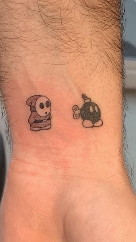 Shy Guy Mario Tattoo, Shy Guy Tattoo Design, Mario Matching Tattoos, Bob Omb Tattoo, Shy Guy Tattoo, Rapper Tattoos Ideas, Doodle Bob Tattoo, Shy Guy Mario, Nintendo Tattoos