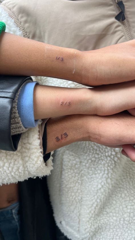 Three siblings wrist showcasing matching tiny tattoo Tattoos For Brother And Sister Sibling, Sibling Of 3 Tattoos, Tattoos For My Siblings, Tattoos To Get For Siblings, Sibling Tats Brother Sister Tattoos, Tattoo Ideas For Triplets, Mini Sibling Tattoos, Tiny Tattoos Siblings, 3 Matching Tattoos Siblings