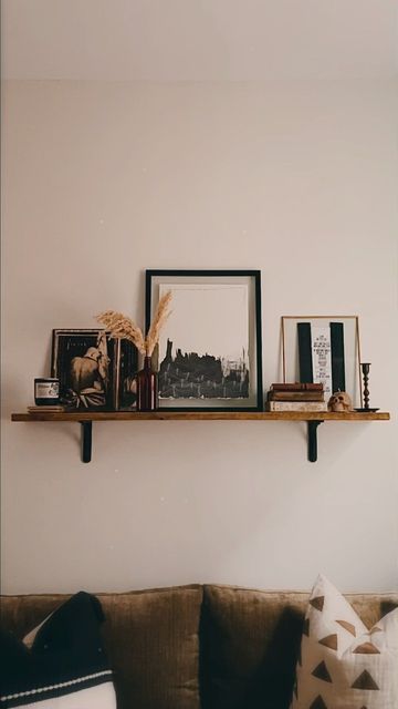 Wall Shelf Ideas Behind Couch, Over The Couch Shelf Decor, Long Wood Shelf Above Couch, Shelf Decor Living Room Above Couch, Long Wall Shelf Living Room, Photos On Shelves, Shelf Above Couch Decor, Living Room Floating Shelves Above Couch, Picture Shelf Living Room