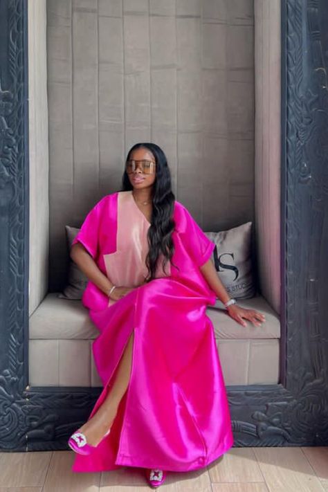 A lady wearing a pink bubu with slit Pink Bubu Gown Styles, Trendy Bubu Gown Styles, Buba Gown Styles, Trendy Birthday Outfits, Mikado Bubu, Latest Bubu Gown Style, Ankara Bubu, Mikado Silk, Hebrew Women