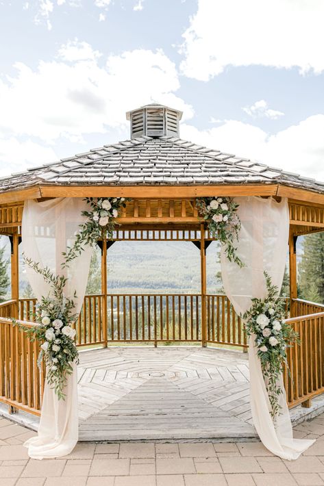 Outdoor wedding gazebo in Canmore, Alberta at Silvertip Resort. Blush and green florals on blush drapery, classic wedding ceremony inspiration. Wedding Gazebo Flowers, Summer Wedding Outdoor Ceremony, Outdoor Wedding Gazebo, Gazebo Wedding Ceremony, Mountain Portraits, Classic Wedding Ceremony, Gazebo Wedding Decorations, Draping Decor, Wedding Platform