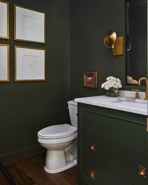 Transform your airy powder room into a moody jewel box with a few pails of paint and a couple of days to spare. This rich, olive-colored bathroom offers ample inspiration with deep green walls and vanity paired with creamy-white ivory accents and lustrous brass hardware. Achieve the same saturated look using similar paint hues like navy, chocolate, purple or oxblood and pair with metallic brass, gold or polished nickel hardware. Dresser To Vanity, Condo Aesthetic, Green Powder Room, Green Bathroom Paint, Olive Green Bathrooms, Powder Room Refresh, Casa Miami, Transitional Powder Room, Small Toilet Design