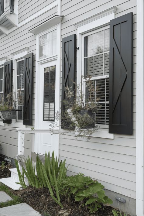 Brighten your home’s exterior with these charming window shutter ideas that boost curb appeal. From colorful paint to stylish hardware each idea adds personality and flair. Explore rustic designs classic patterns modern touches and creative embellishments that will make your home stand out and invite compliments from neighbors and friends. Modern House Shutters Exterior, Exterior Window Header, Front Of House Window Ideas, Black Windows With Shutters, Homes With Black Shutters, Black Shutters Exterior, House Shutters Exterior, Exterior Shutters Ideas, Exterior House Shutters