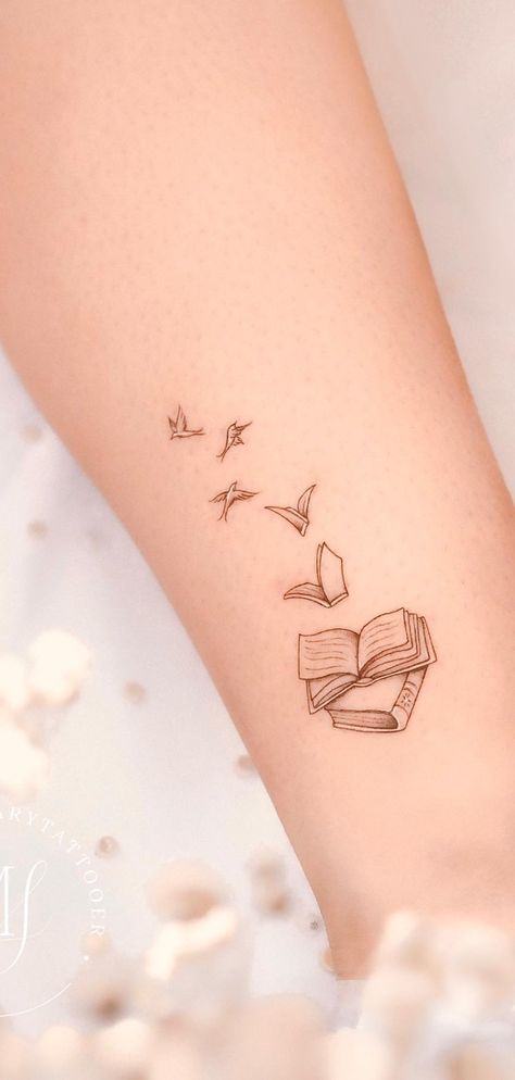 Beautiful book tattoos ideas for readers, tattoos for readers, meaningful tattoos, books tattoos, book tattoos tiny, book tattoos small, book tattoos sleeve, patchwork tattoos ideas, stack of books tattoos, book tattoos ideas simple, fine line art tattoo, book tattoos ideas small, meaningful literary tattoos for book lovers, book tattoos for literature lovers. Cute Small Book Tattoos, Small Reader Tattoo, Bird Book Tattoo, Book To Bird Tattoo, Verity Tattoo Designs, Literary Quotes Tattoos, Heart Book Tattoo, Books And Birds Tattoo, Cute Book Tattoos For Women