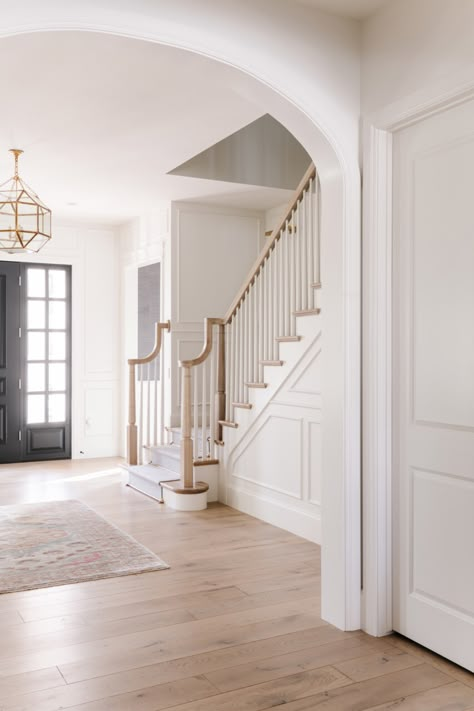 Modernize Colonial House Interior, White Walls Traditional Home, Modern French Country Front Door, Stairs By Entryway, Colonial Style Staircase, Stair Baluster Ideas Wood, Modern Colonial Foyer, Center Hall Colonial Staircase, Sandbar Oak Cali Bamboo