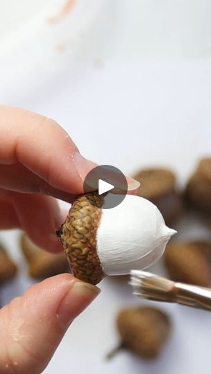 How to Paint an Acorn Garland | photograph | This pretty foraged acorn garland is lovely for a fall mantel or tiered tray! Photos and supply list ->... | By Sustain My Craft Habit - Clever DIY, Crafts & Upcycling IdeasFacebook Painting Acorns Fall, Acorn Ideas Projects, Craft With Acorns, Acorn Christmas Ornaments Diy, Crafts Using Acorns, How To Paint Acorns, Painting Acorns Diy, Acorn Christmas Crafts, Acorn Cap Crafts