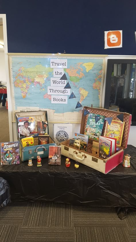 School Displays Inspirational, Travel The World Through Books Display, Book An Adventure Display, School Library Reading Corner, Bookshop Display Ideas, Adventure Begins At Your Library Decorations, Travel Library Display, Book Fair Display Ideas, Book Display Table