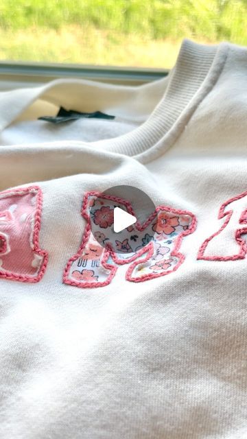 Stitchin With Samantha | Embroidery Patterns & Kits on Instagram: "Using Olive’s old newborn onesies to make a MAMA sweatshirt 🪡✨   I am obsessed with how this turned out and I can’t wait to wear it all the time as a keepsake for her earliest days!🥹  I have been wanting to make a onesie sweatshirt for a year now, but I was too scared to make it with a sewing machine. I was inspired by @flynn_and_mabel to try out reverse appliqué and this technique was perfect for this project!!" Embroidery On Sweatshirts Words, Reverse Embroidery Sweatshirt Diy, Hand Stitched Embroidery Shirt, Sewing Fabric Letters On Shirt, Embroidered Pouch Diy, How To Applique With Embroidery Machine, Diy Star Sweatshirt, Diy Mama Sweatshirt, Reverse Embroidery Sweatshirt