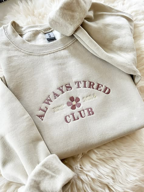 Embroidered Always Tired Club New Mom Gift Sweater - Embroidered - Unisex Crewneck Sweatshirt - Designed with pre-shrunk soft air-jet spun yarn - Loose fit for a comfortable feel * Sizing and Colors - Please refer to sizing and color charts in the images * Fabrication - 50% cotton, 50% polyester * Care Instructions - Turn inside out and machine wash cold on delicate cycle - Dry on low heat setting - Do not bleach - Do not dry clean - Do not iron directly on design * Processing and Shipping Times - Please allow 4-10 business days for your order to be processed and stitched - Standard shipping takes 3-5 days - Please note that these times are estimated by USPS and may take longer - Please make sure your shipping address is correct before placing an order - Stitched and Shipped in the USA * R Trending Crewneck Designs, Sweater Ideas Design, Embroided Hoodie, Etsy Sweatshirts, Outfit Ideas Shirt, Trendy Crewneck Sweatshirt, Shirt Outfit Ideas, Trendy Crewneck, Always Tired