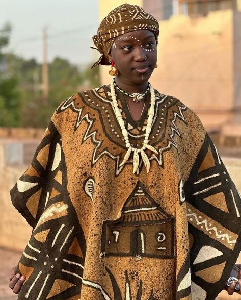 Bogolan, or mud cloth, is Mali’s centuries-old craft that fuses history, art, and fashion in the most striking way. As seen in these videos, artisans meticulously hand-paint designs with fermented mud, each line telling a story steeped in tradition. Bold geometric patterns and earthy tones aren’t just about aesthetics—they symbolize protection, community, and a deep connection to the land. What makes it even more special? Every piece is handcrafted, carrying the soul of Mali’s rich heritage... Worldbuilding Clothes, West African Clothing, Africa Fashion Traditional, African Clothing Stores, Africa Tribes, Tribe Fashion, Africa Photography, Traditional African Clothing, African Pattern Design