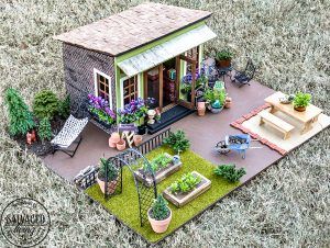 Tour a miniature vintage garden shop dollhouse for great ideas for your own dollhouse decor. See how to make a cozy home, lush garden and outdoor miniature yard! COmplete with garden gnomes, miniature potted plants and sitting areas. #dollhouse #miniatures #DIYdollhouse #vintagegarden #tinydecor Make A Cozy Bed, Outdoor Dollhouse, Miniature Cabin, Dollhouse Landscaping, Diy Mirrored Furniture, Diy Miniature Garden, Realistic Kitchen, Japanese Fairy, Miniature Greenhouse