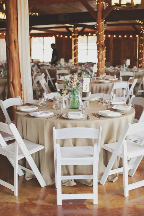 Natural linens on round tables with white resin chairs. White Chairs Wedding, Barn Wedding Centerpieces, Round Wedding Tables, Tan Wedding, Candle Wedding Centerpieces, Wedding Table Linens, Wedding Tablecloths, Beige Wedding, Round Chair