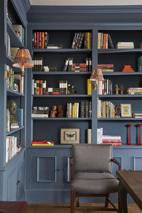 Designed to complement the Georgian architecture we had the joinery, that wraps around this library, painted in Farrow and Ball’s Stiffkey Blue. The colour elevates the solid oak bookcase and gives the room a masculine grandeur. Shelves Library, Blue Library, Bedside Sconces, Library Study Room, Office Paint Colors, Stiffkey Blue, Open Plan Kitchen Diner, Office Paint, Library Study