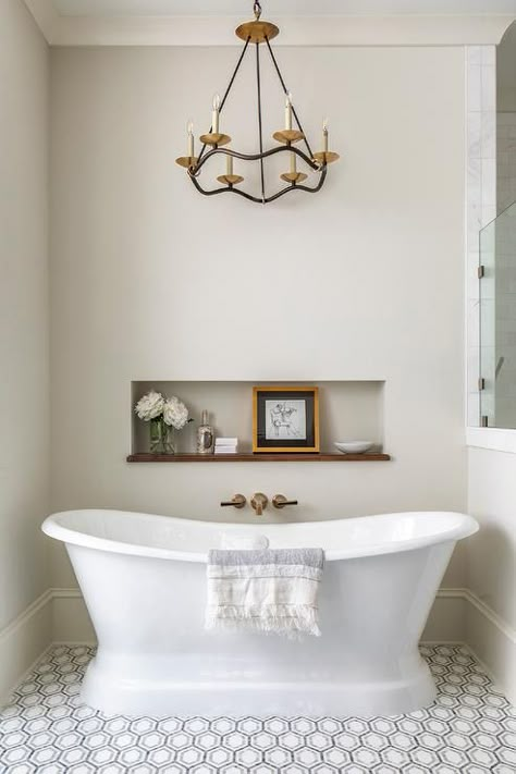 Choros Chandelier above a freestanding vintage roll-top bathtub and a niche for bath essentials and decorative accents. Transitional Bathroom Design, Wall Faucet, Vintage Tub, Bathtub Decor, Timeless Bathroom, Bathtub Walls, Roll Top Bath, Master Bath Ideas, Transitional Bathroom