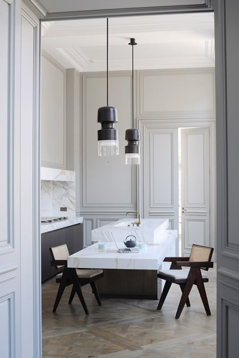 In the kitchen, all technical elements are hidden behind calacatta marble partitions. Bronze ‘Fingi’ suspension lighting by Eric Schmitt (Eric Schmitt). Office armchairs by Pierre Jeanneret (Galerie 54).  http://www.yatzer.com/joseph-dirand-saint-germain-paris // Photo © Adrien Dirand / AD France n° 119, September/October 2013. Modern French Interiors, Glamorous Kitchen, Joseph Dirand, Minimalist Dekor, Parisian Apartment, Kitchen Marble, Design Del Prodotto, French Interior, Kitchen Interior Design