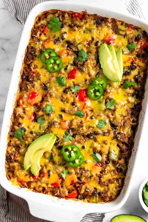 Comfort food doesn’t get much better than this beef burrito casserole. Seasoned ground beef, veggies, rice, and beans are baked together and then topped with melty cheese for a delicious healthy casserole recipe. High protein, gluten-free, and great for meal prep.