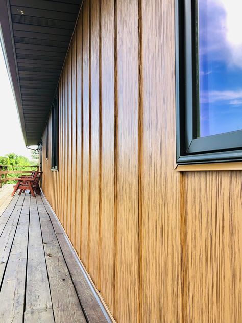 Board And Batten Siding With Black Metal Roof, Metal Siding And Roof Colors, Brown Metal Siding House, Metal Batten Siding, Wood Grain Siding, Composite Wood Siding Exterior, Metal Siding Cabin, Wood Board And Batten Exterior, Wood Look Steel Siding