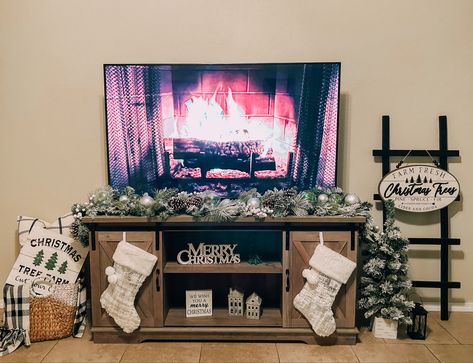 Christmas Decor Under Tv Stand, Christmas Living Room Tv Stand, Under The Tv Christmas Decor, Tv Fireplace Christmas Decor, Christmas Decorations For Tv Stand, Christmas Tv Stand Decor Ideas, Entertainment Stand Christmas Decor, Stocking On Tv Stand, Christmas Tv Unit