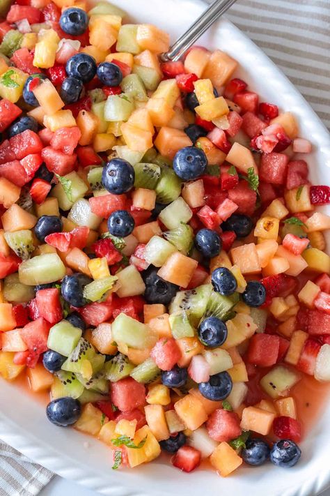 This fruit salad is flavored with honey lime and vanilla to make a deliciously fresh and sweet salad. Fruit Salad Table Party Ideas, Fruit Salad With Lime Dressing, Honey Lime Fruit Salad Dressing, Chopped Fruit Salad, 15th Bday Party Ideas, Honey Lime Fruit Salad, Birthday Party Meals, Fruit Salad With Honey, Mexican Fruit Salads