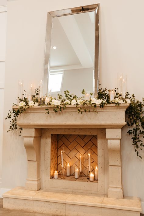 Wedding Garland Fireplace, Fireplace Mantle Flowers, Wedding Flowers Fireplace Mantles, Fireplace Garland Wedding, Candles In Fireplace Wedding, Chimney Wedding Decor, January Fireplace Decor, Floral Arrangements For Mantels Fireplace Mantles, Summer Wedding Fireplace Decor