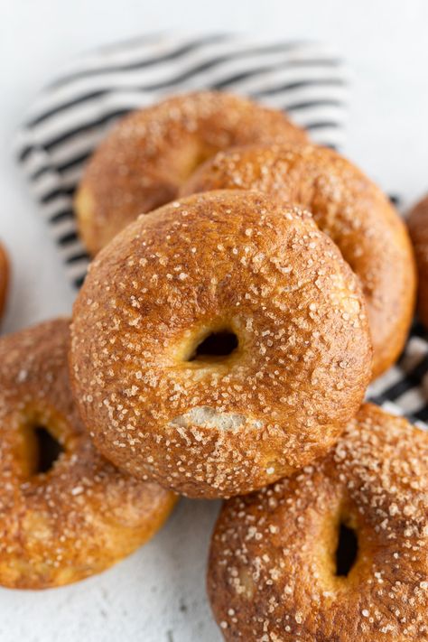 Close up of a pretzel bagel on a pile of bagels. Pretzel Bagel Recipe, Homemade Bagels Easy, Pretzel Bagels, Best Bagel Recipe, Pretzel Bread Recipe, Bagels Recipe Homemade, Pretzel Bagel, Bagels Homemade, Bagels Easy