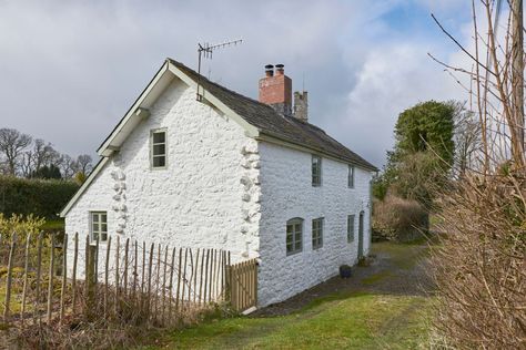 The cottage, which is said to have been built in 7 Modern Kitchen Extensions, California Cottage, Inset Fireplace, Welsh Cottage, Welsh Countryside, Cottage Modern, Houses In France, Reclaimed Doors, Flagstone Flooring