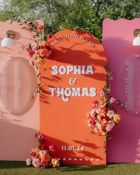 Eclectic Wedding Signs, Pink And Orange Wedding Aesthetic, Pink And Orange Wedding Signage, Wedding Signage Colorful, Pinks And Orange Wedding, Pink And Orange Wedding Decor, Red Pink Orange Wedding, Bright Pink And Orange Wedding, Wedding Signs With Flowers