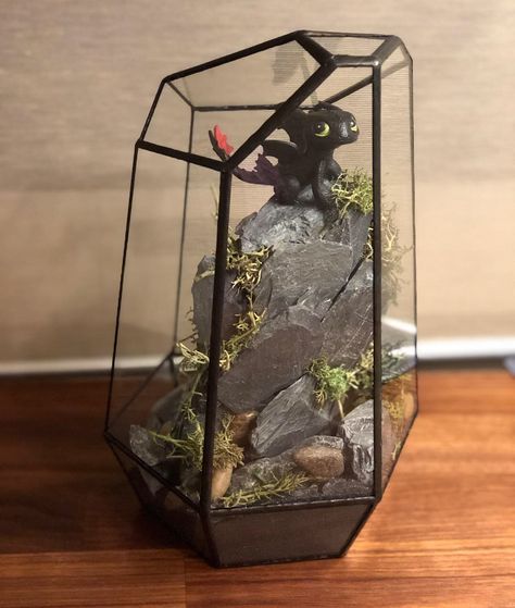 I made this how to train your dragon terrarium for my husband! It turned out great! #toothless #howtotrainyourdragon #terrarium #dreamworks #dreamworksdragons Dragon Terrarium Craft, How To Train Your Dragon Room Decor, How To Train Your Dragon Centerpiece, How To Train Your Dragon Bedroom Ideas, How To Train Your Dragon Room, How To Train Your Dragon Room Ideas, Diy Dragon Decor, How To Train Your Dragon Decorations, How To Train Your Dragon Bedroom