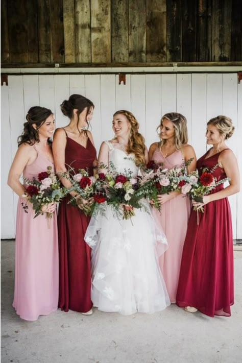 Bridesmaids wearing red and pink dresses in a rustic fall wedding. Wine Red And Pink Wedding, Pink Red Burgundy Wedding, Red And Pink Wedding Bridesmaid Dresses, Valentines Day Bridesmaid Dresses, Bridesmaid Dresses Burgundy And Blush, Deep Red And Pink Wedding, Pink And Red Wedding Groomsmen, Dusty Pink And Red Wedding, Blush Pink And Red Wedding Theme