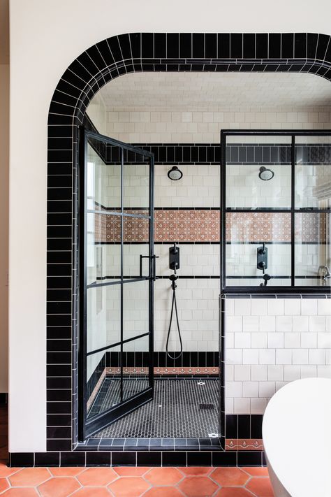 By scaling back the size of a dual shower with Phylrich fixtures into a still-generous space, the primary bathroom gained intimacy and character. Mission Tile West-clad walls harmonize with Saltillo tile floors. Shower Built Into Wall, Bathroom Tiles Black And White, Moody Bathroom White Tile, Spanish Revival Tile, Bathroom With Black And White Tile Floor, Cool Bathroom Tile, Black Bathroom Floor Tile, Saltillo Tile Bathroom, Full Tile Bathroom