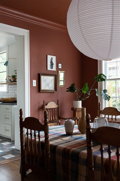 A 1920s Tudor Reno in Waco, Texas, That Traded Shiplap for Bold Paint | domino Midcentury Modern Dining Room, 70s Table, Orange Dining Room, Brown Dining Room, Dining Room Accent Wall, Dining Room Victorian, Red Dining Room, Jeff Jones, Paper Lantern Lights