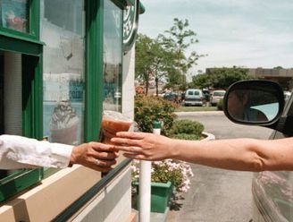 A driver reaches for her coffee order through a window at a drive-up Starbucks Coffee shop June 23, 2000 in Lombard, IL. Legislators in New Jersey want to pass a… Drive Through Coffee Shop, Starbucks Drive Thru, Coffee Drive Thru, Drive Thru Coffee, Distracted Driving, Pray For America, Brand Character, Architecture Collage, Coffee Photos