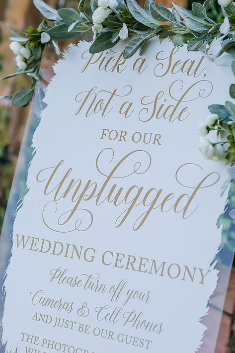 "Click on the following link to browse HUNDREDS more designs in our shop!! https://pinkposiesandpearls.etsy.com/  | Welcome to Pink Posies and Pearls Wedding and Gift Boutique | Make a grand statement at your wedding with our acrylic signs! This acrylic is a display material that is strong, moisture resistant & visually clearer than glass, not to mention shatterproof! The lettering can be selected from your unique color palette. No vinyl or stickers are used! We print on your design with high quality, UV ink, which make it a permanent design (no wrinkles, peeling or bubbles like with vinyl). It is personalized with the Bride and Groom's names and wedding date. This beautiful sign provides an easy way to add an elegant and custom touch to your wedding or next special event. Choose your cust Pick A Seat Not A Side Unplugged, Unplugged Wedding Sign Acrylic, Pick A Seat Not A Side Wedding Sign, Pick A Seat Not A Side Sign, Pick A Seat Not A Side, Bond Wedding, Unplugged Ceremony Sign, Acrylic Wedding Signs, Unplugged Ceremony