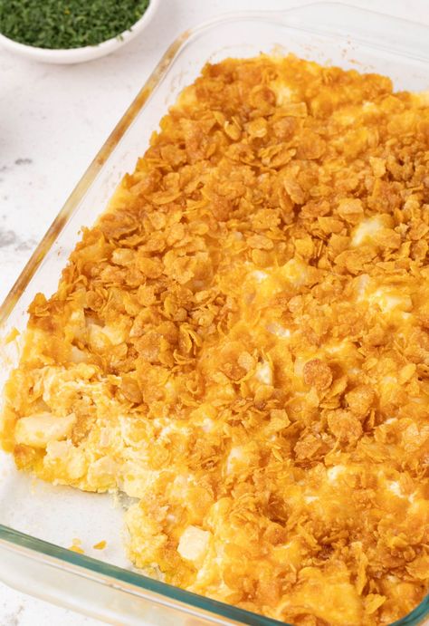 A pan of cooked funeral potatoes Chelsey Potatoe Casserole, Potatoes With Corn Flakes On Top, Cheesy Potatoes With Frosted Flakes, Schwartzie Potatoes, Cubed Potato Casseroles, Corn Flake Potato Casserole, Potatoe Cheese Casserole, Mr Dells Potato Casserole, Cheesy Potatoes Easy Quick