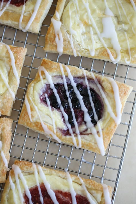 Cream Cheese and Berry Danishes are easy to assemble, quick to bake, and yield impressive results!  Flaky dough and sweet cream cheese filling are dotted with berry jam and a sweet glaze for the perfect pastry! Strawberry Cream Cheese Danish Puff Pastry, Puff Pastry Recipes Danish, Easy Cheese Danish Puff Pastries, Blackberry Cream Cheese Puff Pastry, Phyllo Dough And Cream Cheese Recipes, Cream Cheese And Jam Puff Pastry, Berry Custard Pastry, Puff Pastry Cream Cheese Fruit Tarts, Cherry Cream Cheese Puff Pastry