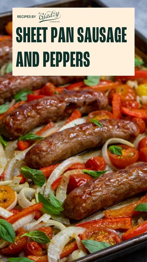 There is a pan with baked Italian sausage links, sliced peppers, onions, cherry tomatoes, and fresh basil scattered throughout the pan. Sheet Pan Sausage And Peppers, Sausage Potatoes And Peppers, Italian Sausage And Peppers, Sheet Pan Sausage, Italian Sausages, Giada Recipes, Italian Night, Hoagie Rolls, Sheet Pan Suppers