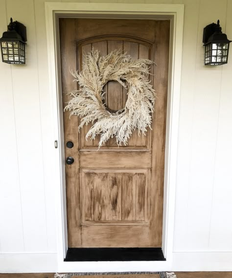 With a few simple steps, transform your door to look like an actual real-wood door. Fake Wood Front Door Paint, Black House Wood Door, Front Door Remodel Before And After, How To Paint Front Door Wood, Diy Faux Wood Grain How To Paint, How To Paint A Door To Look Like Wood, Paint Door To Look Like Wood, Paint Metal Door To Look Like Wood, Paint Front Door To Look Like Wood