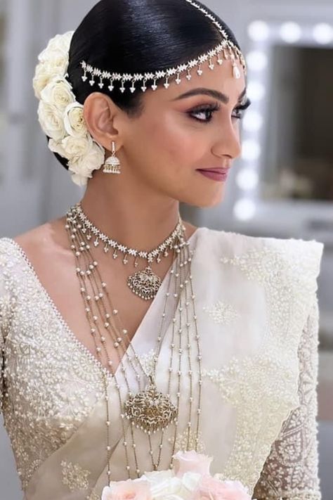 Find the best bridal makeup artists in your budget & desired city with contact information, portfolio & trusted reviews at Weddingbazaar - Trusted Wedding Services for Every Indian Wedding! #southindianwedding #southindianbride #southindianbridemakeup #southindianbridemakeuplook #southindianbridemakeover South Indian White Sari Look, White Saree Jewellery Ideas, Jewellery On White Saree, Sri Lanka Wedding Dress, Bridal Saree Sri Lankan, Sri Lankan Bridal Saree, Sri Lankan Jewelry, White Sarees For Wedding, Kandyan Wedding Saree