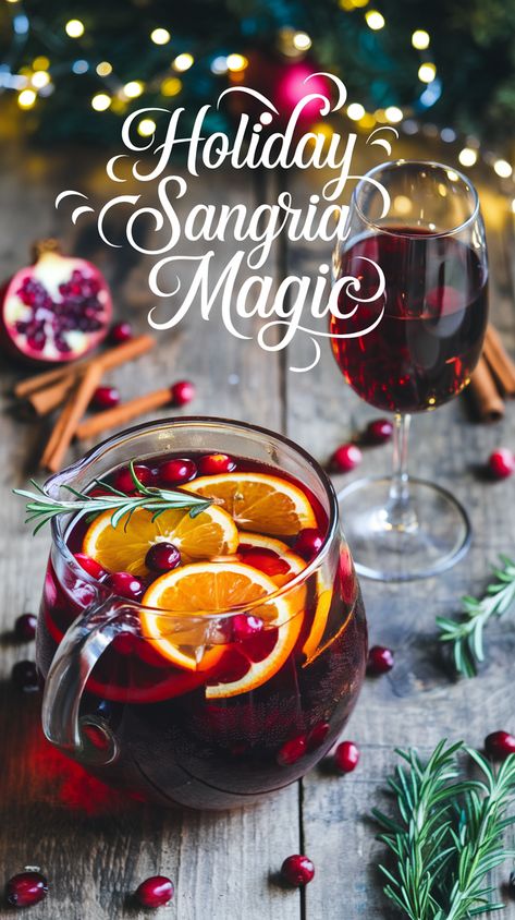 Christmas sangria pitcher with orange slices, cranberries, rosemary, on a rustic table with pomegranate seeds, cinnamon, string lights, and elegant wine glass.