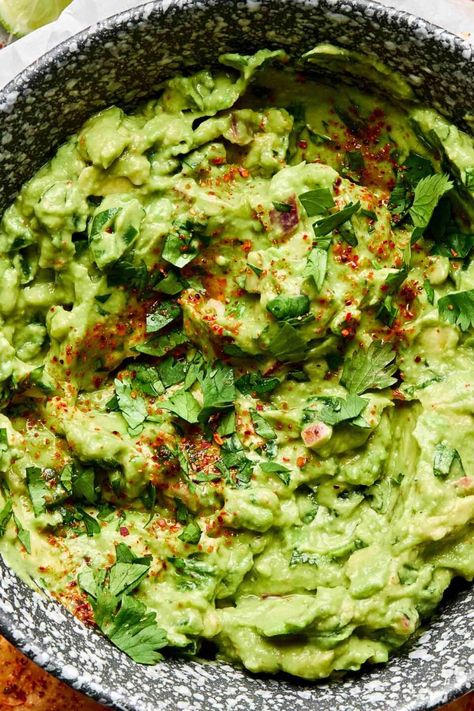 Inspired by my restaurant days, this easy Fresh Guacamole recipe combines not 1 but 2 ripe avocados with jalapeños, red onion, fresh lime juice, and lots of cilantro. Smashed together in a zip-top bag (or molcajete!) with my secret ingredient –Tajín! – the result is a chunky-creamy guacamole dip with bright, tangy, and spicy flavor. Ready in 15 minutes or less and with all the citrus, this homemade guacamole never browns! #guacamole #guacamolerecipe #guacamoledip #avocadorecipes #mexicanfood Fresh Guacamole Recipe, Spicy Guacamole Recipe, Avocado Dip Recipe, Creamy Guacamole, Guacamole Recipes, Homemade Guacamole Recipe, Guacamole Ingredients, Spicy Guacamole, Guacamole Recipe Easy