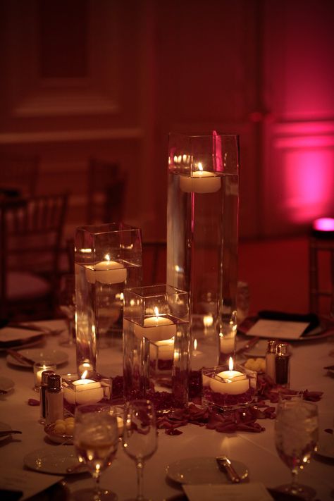 Romantic, simple centerpiece with candles and rose petals Candle And Rose Petal Centerpieces, Vases With Floating Candles, Candles And Rose Petals, Floating Petals, Centerpieces Vases, Floating Centerpieces, Floating Candle Centerpieces, Casino Party Foods, Casino Decorations