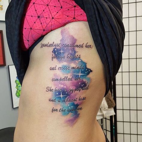 blue-purple-pink-space-themed-tattoos-with-quote-rib-cage-tattoo-on-woman-wearing-black-pink-top Watercolor Galaxy Tattoo, Galaxy Tattoo Sleeve, Rib Tattoos For Women, Ribcage Tattoo, Galaxy Tattoo, Best Tattoos For Women, Omerta Tattoo, Skeleton Hand Tattoo, Forearm Tattoo Women