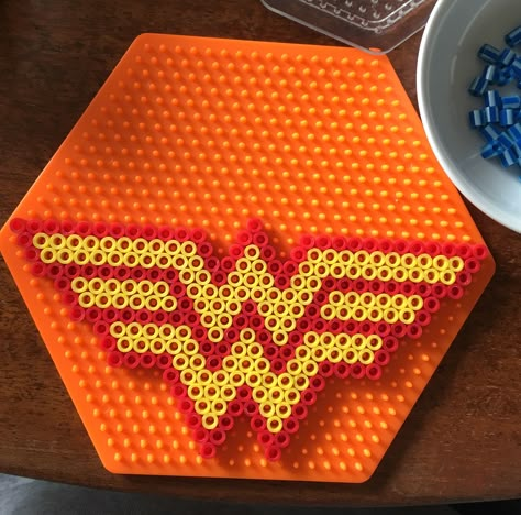 Perler WW Wonder Woman symbol logo pattern on hexagon pegboard Logo Perler Beads, Superhero Perler Bead Patterns, Queen Perler Beads, Hexagon Perler Bead Patterns, Perler Beads Hexagon Pegboard, Wonder Woman Perler Bead Patterns, Infinity Gauntlet Perler Beads, Wonder Woman Perler Beads, Dc Perler Beads